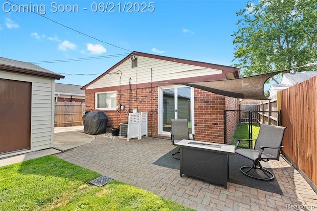 30546 Townley St, Madison Heights, MI 48071 - back of house featuring brick siding, a patio area, and a fire pit