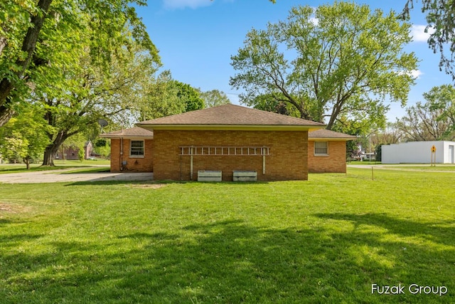4733 136th Ave, Hamilton, MI 49419 - view of property exterior with a yard, brick siding, and a shingled roof