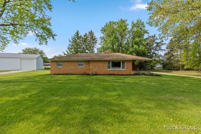 4733 136th Ave, Hamilton, MI 49419 - back of house featuring a lawn, a chimney, brick siding, and a detached garage
