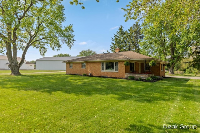 4733 136th Ave, Hamilton, MI 49419 - ranch-style home featuring a front yard, a chimney, brick siding, and a porch