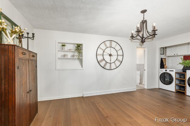 4733 136th Ave, Hamilton, MI 49419 - unfurnished dining area with a chandelier, washer and dryer, hardwood / wood-style floors, a textured ceiling, and built in shelves