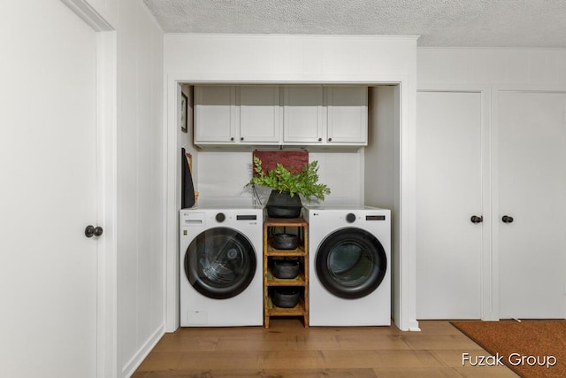 4733 136th Ave, Hamilton, MI 49419 - laundry area with washing machine and dryer, crown molding, a textured ceiling, wood finished floors, and cabinet space