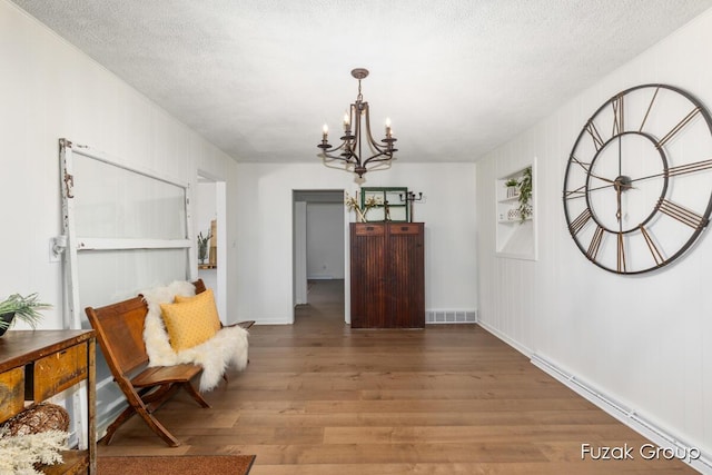4733 136th Ave, Hamilton, MI 49419 - entrance foyer with a chandelier, wood finished floors, and a textured ceiling