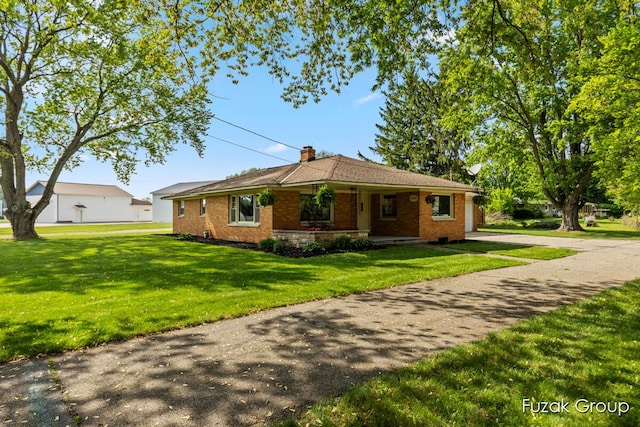 4733 136th Ave, Hamilton, MI 49419 - ranch-style house with a front yard, a chimney, brick siding, and covered porch