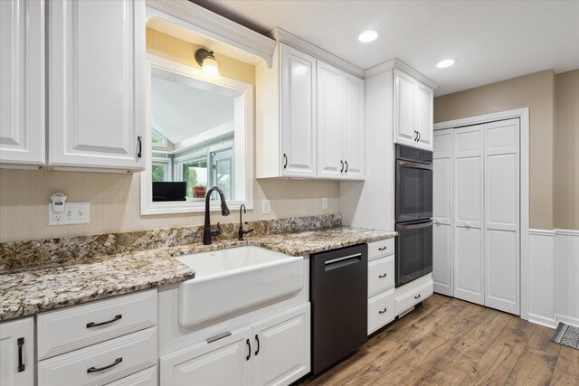 30170 Beeson St, Dowagiac, MI 49047 - kitchen with dishwasher, wood finished floors, white cabinets, light stone countertops, and recessed lighting