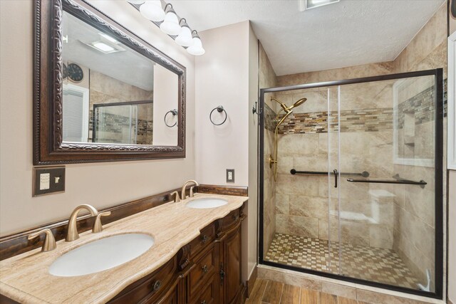 30170 Beeson St, Dowagiac, MI 49047 - full bath with a shower stall, double vanity, and wood finished floors