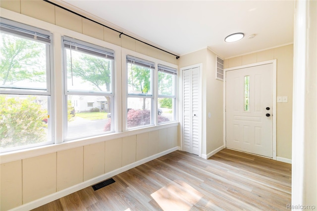3820 17th St, Grosse Ile, MI 48192 - entrance foyer featuring plenty of natural light, light wood-style floors, and crown molding