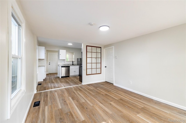 3820 17th St, Grosse Ile, MI 48192 - unfurnished living room featuring light wood-style floors and baseboards