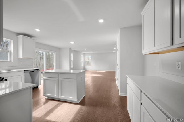 4286 Oak St, Grand Blanc, MI 48439 - kitchen featuring stainless steel dishwasher, light countertops, dark wood-style flooring, white cabinetry, and recessed lighting