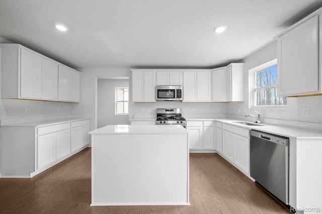 4286 Oak St, Grand Blanc, MI 48439 - kitchen featuring appliances with stainless steel finishes, dark wood finished floors, a center island, recessed lighting, and light countertops