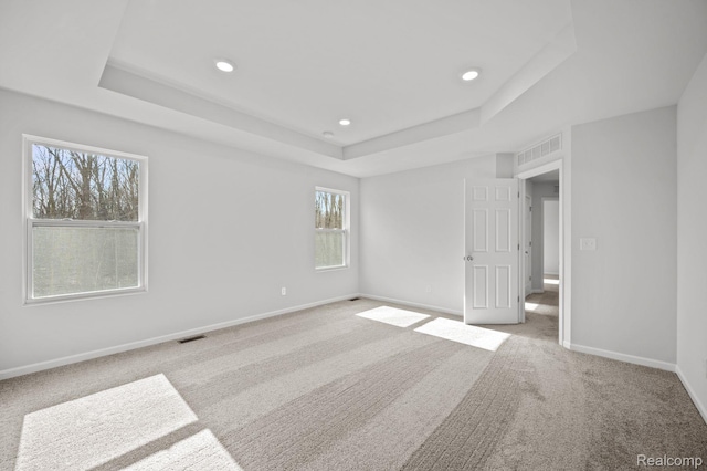 4286 Oak St, Grand Blanc, MI 48439 - unfurnished bedroom with a tray ceiling, carpet floors, and recessed lighting
