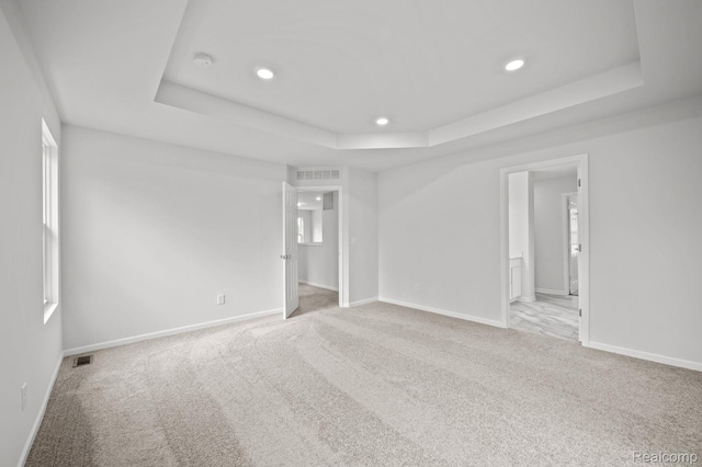 4286 Oak St, Grand Blanc, MI 48439 - spare room with a tray ceiling, recessed lighting, and carpet