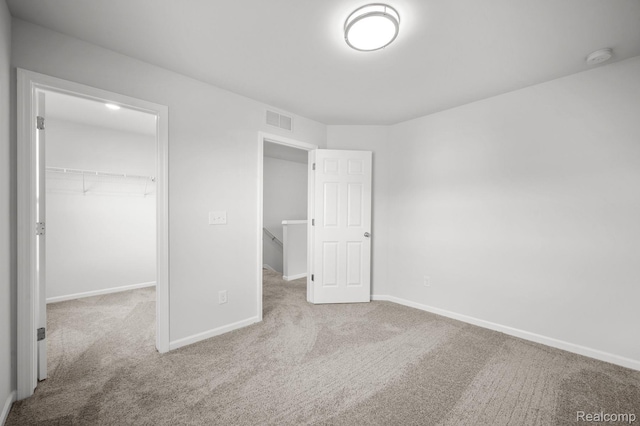 4286 Oak St, Grand Blanc, MI 48439 - unfurnished bedroom featuring carpet flooring, a walk in closet, and a closet
