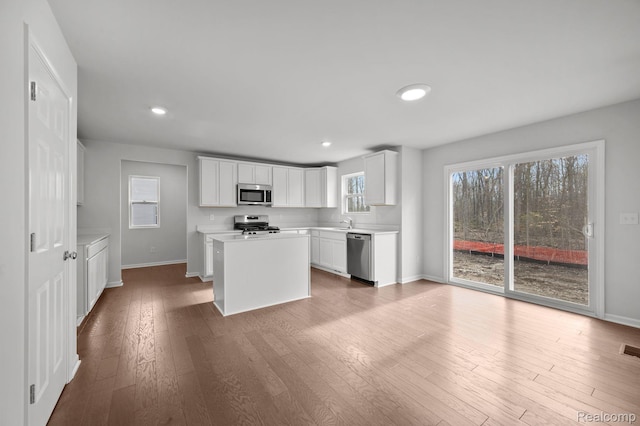 4286 Oak St, Grand Blanc, MI 48439 - kitchen with stainless steel appliances, light countertops, wood finished floors, recessed lighting, and a center island