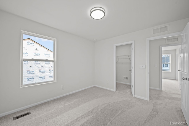 4303 Oak St, Grand Blanc, MI 48439 - unfurnished bedroom featuring carpet floors, a spacious closet, and a closet