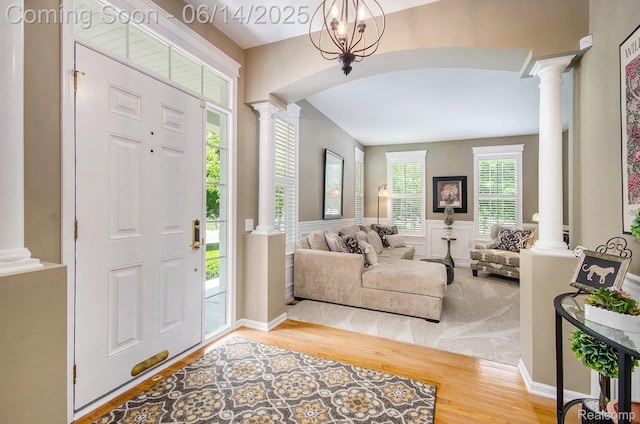 3839 Springwood Ct, Auburn Hills, MI 48326 - entrance foyer featuring ornate columns, wood finished floors, and a wainscoted wall
