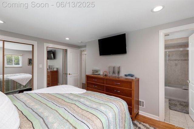24960 S Cromwell Dr, Franklin, MI 48025 - bedroom featuring recessed lighting, connected bathroom, two closets, and light wood-type flooring