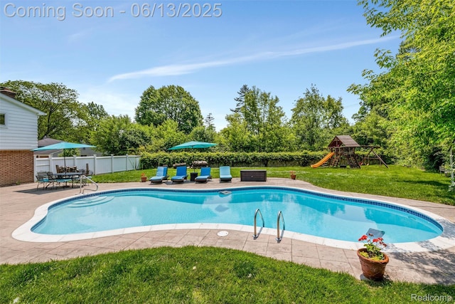 24960 S Cromwell Dr, Franklin, MI 48025 - view of swimming pool featuring a patio, a fenced backyard, a playground, and view of wooded area