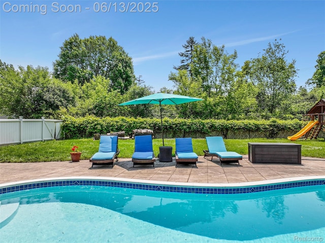 24960 S Cromwell Dr, Franklin, MI 48025 - view of pool with a fenced backyard, a playground, a patio, and view of wooded area