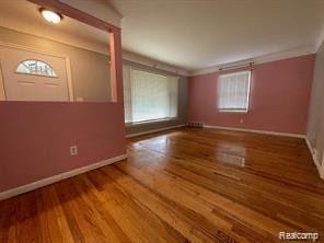 8889 Plainview Ave, Detroit, MI 48228 - spare room featuring wood finished floors and ornamental molding