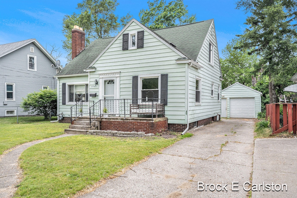 2945 Roosevelt Rd, Roosevelt Park, MI 49441 - bungalow-style house with driveway, an outdoor structure, a detached garage, roof with shingles, and a chimney