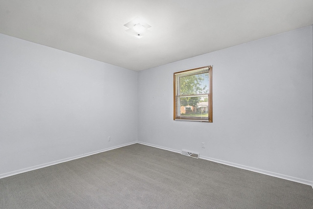 880 Andover Ct SE, Grand Rapids, MI 49508 - unfurnished room featuring dark colored carpet and baseboards