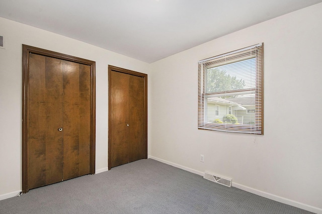 880 Andover Ct SE, Grand Rapids, MI 49508 - unfurnished bedroom featuring multiple closets and carpet floors