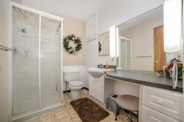 441 Hillcrest Dr, Lake, MI 48632 - full bath with a shower stall, vanity, tile walls, and wainscoting