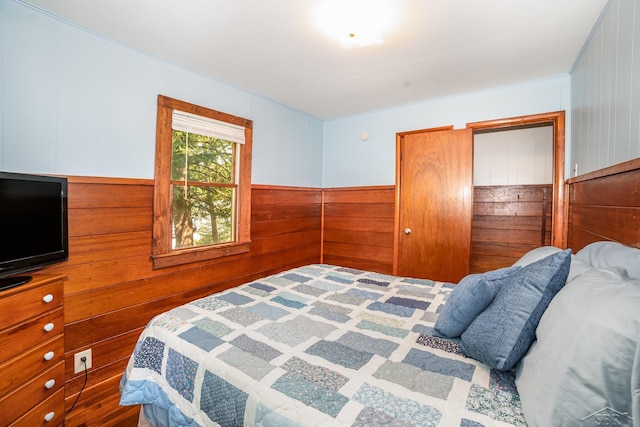 441 Hillcrest Dr, Lake, MI 48632 - bedroom featuring wooden walls and a wainscoted wall
