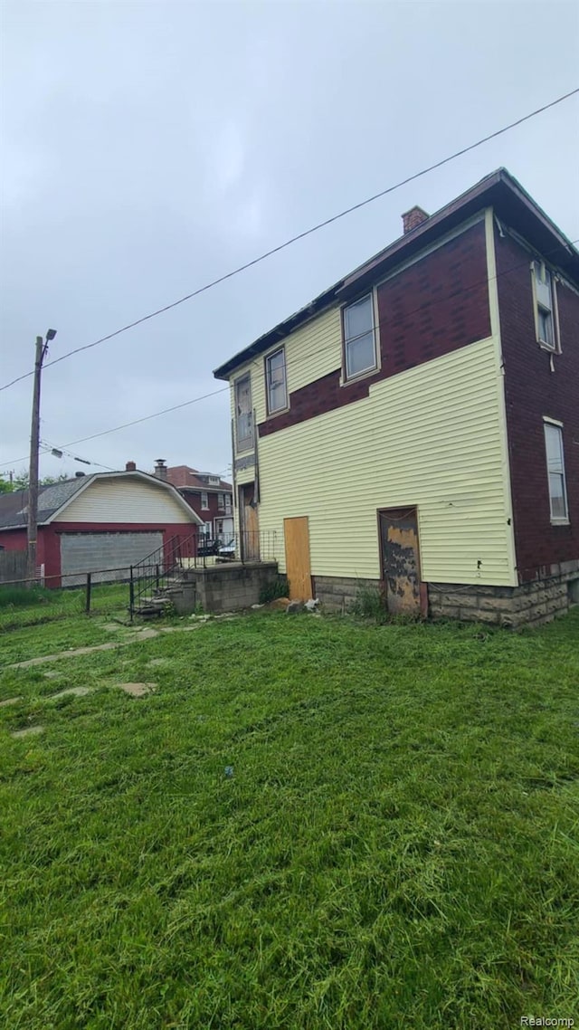 193 Division St, River Rouge, MI 48218 - view of property exterior with brick siding and a chimney