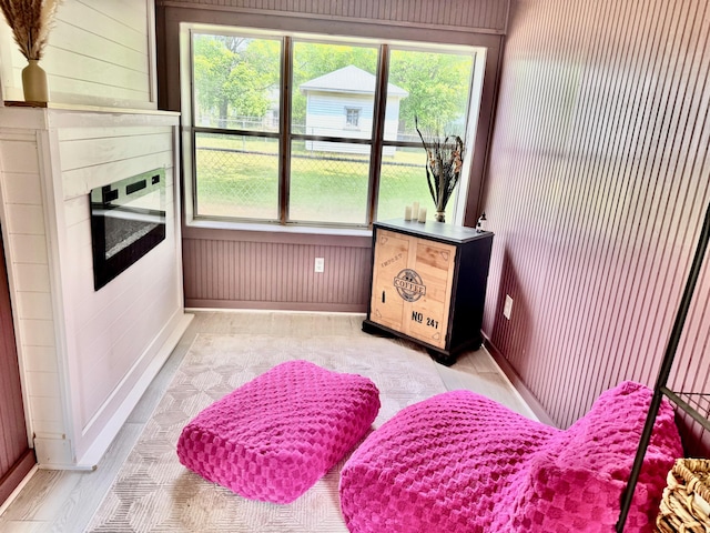 3515 Adams St, Kalamazoo, MI 49008 - living area with plenty of natural light, wooden walls, and a fireplace