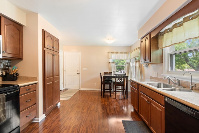 833 S Lansing St, Mason, MI 48854 - kitchen featuring black appliances, dark wood-style floors, light countertops, and brown cabinets