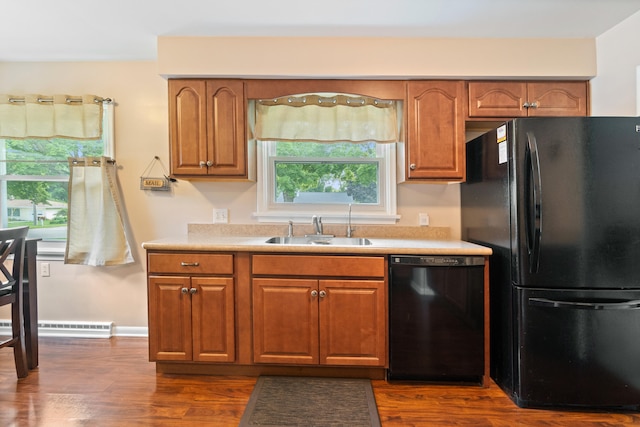 833 S Lansing St, Mason, MI 48854 - kitchen featuring black appliances, brown cabinetry, and light countertops