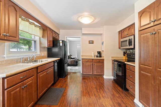 833 S Lansing St, Mason, MI 48854 - kitchen featuring black appliances, dark wood finished floors, light countertops, and brown cabinetry