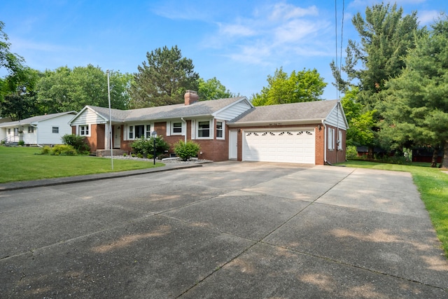 833 S Lansing St, Mason, MI 48854 - ranch-style house with brick siding, an attached garage, a front yard, driveway, and a chimney