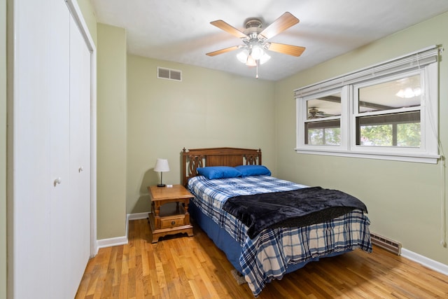 833 S Lansing St, Mason, MI 48854 - bedroom with light wood-style floors, baseboard heating, a closet, and ceiling fan