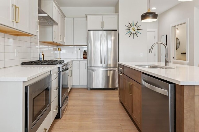 929 Harbor Dr E # 27, Saint Joseph, MI 49085 - kitchen with appliances with stainless steel finishes, wall chimney exhaust hood, light wood finished floors, light countertops, and recessed lighting