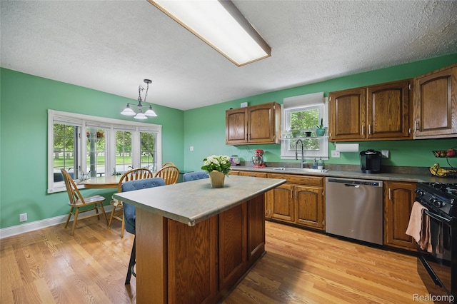 1614 Colorado St, Marysville, MI 48040 - kitchen with stainless steel dishwasher, black gas range oven, a center island, a textured ceiling, and a breakfast bar