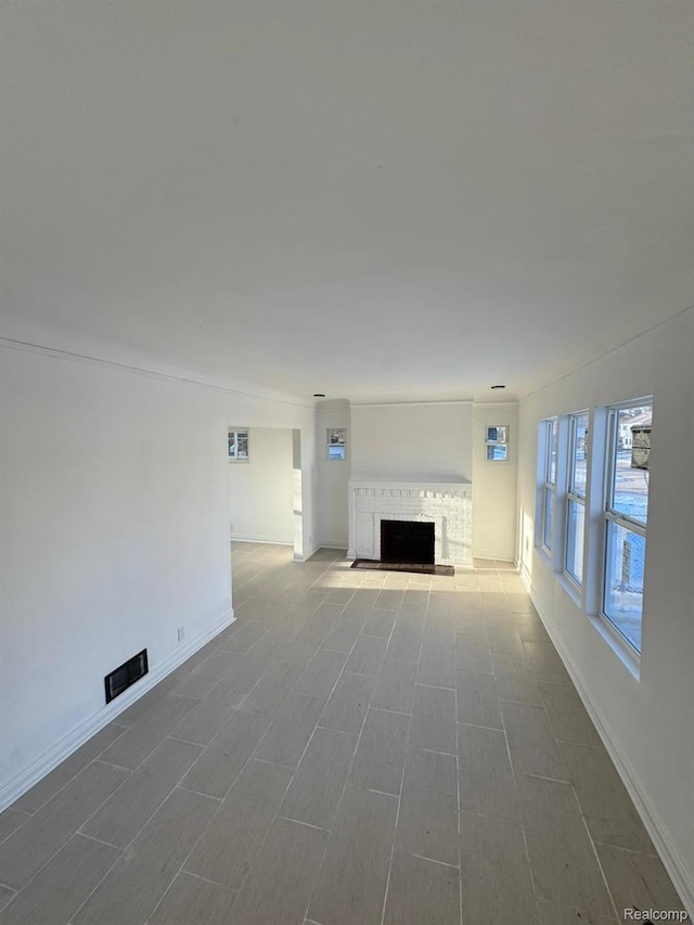 4707 Buckingham Ave, Detroit, MI 48224 - unfurnished living room with a brick fireplace and baseboards