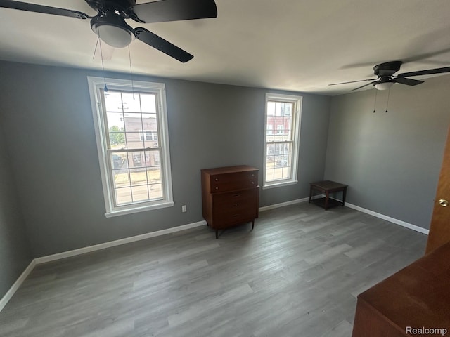 910 Monroe St, Carleton, MI 48117 - spare room with ceiling fan, plenty of natural light, and wood finished floors