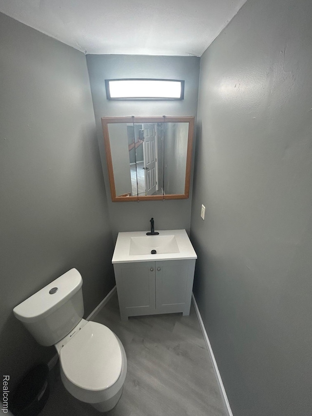 910 Monroe St, Carleton, MI 48117 - bathroom featuring vanity and wood finished floors