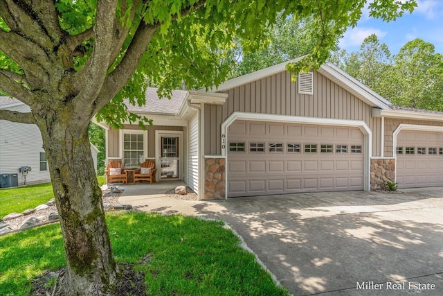 610 Riverwalk St Unit 18, Hastings, MI 49058 - view of front of home with stone siding, a garage, concrete driveway, and board and batten siding
