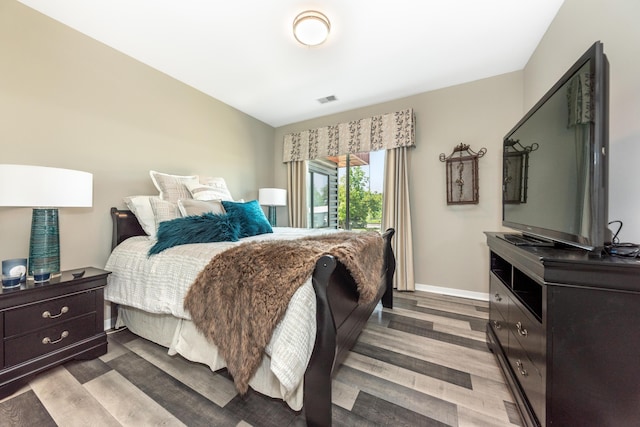 293 N 2nd St Unit 201, Brighton, MI 48116 - bedroom with wood finished floors and baseboards