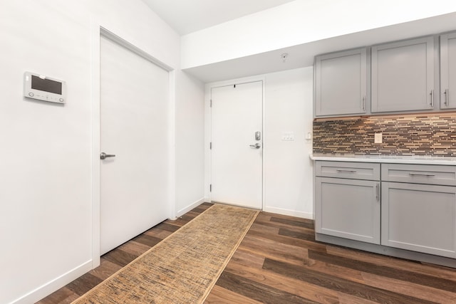 293 N 2nd St Unit 201, Brighton, MI 48116 - kitchen featuring gray cabinets, backsplash, light countertops, and dark wood-style flooring