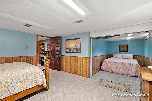 69 Cheyenne Ave, Holland, MI 49424 - carpeted bedroom featuring wainscoting and wood walls