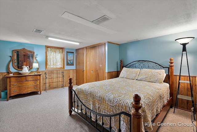 69 Cheyenne Ave, Holland, MI 49424 - carpeted bedroom with wooden walls, a wainscoted wall, and a closet