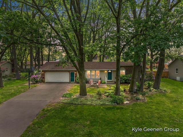 69 Cheyenne Ave, Holland, MI 49424 - view of front of home featuring a garage, concrete driveway, and a front lawn