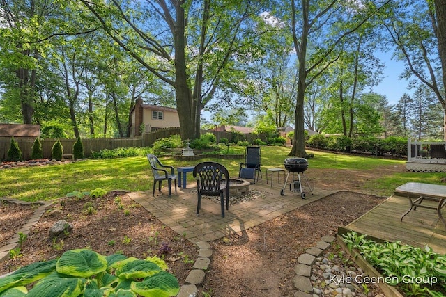 69 Cheyenne Ave, Holland, MI 49424 - fenced backyard featuring a fire pit and a patio area