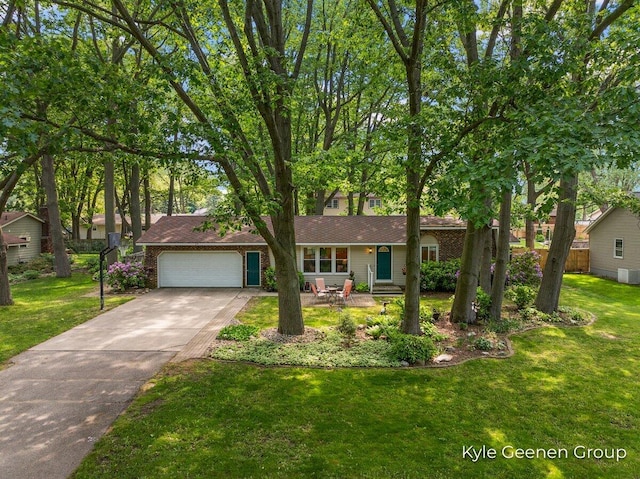 69 Cheyenne Ave, Holland, MI 49424 - view of front of house with an attached garage, concrete driveway, and a front yard