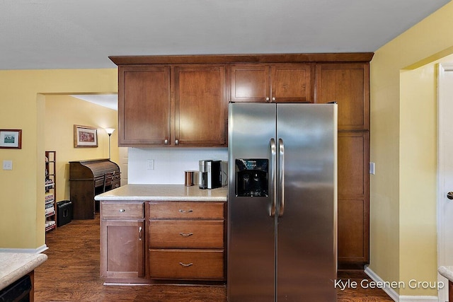 69 Cheyenne Ave, Holland, MI 49424 - kitchen featuring stainless steel fridge with ice dispenser, light countertops, dark wood-style flooring, and brown cabinetry